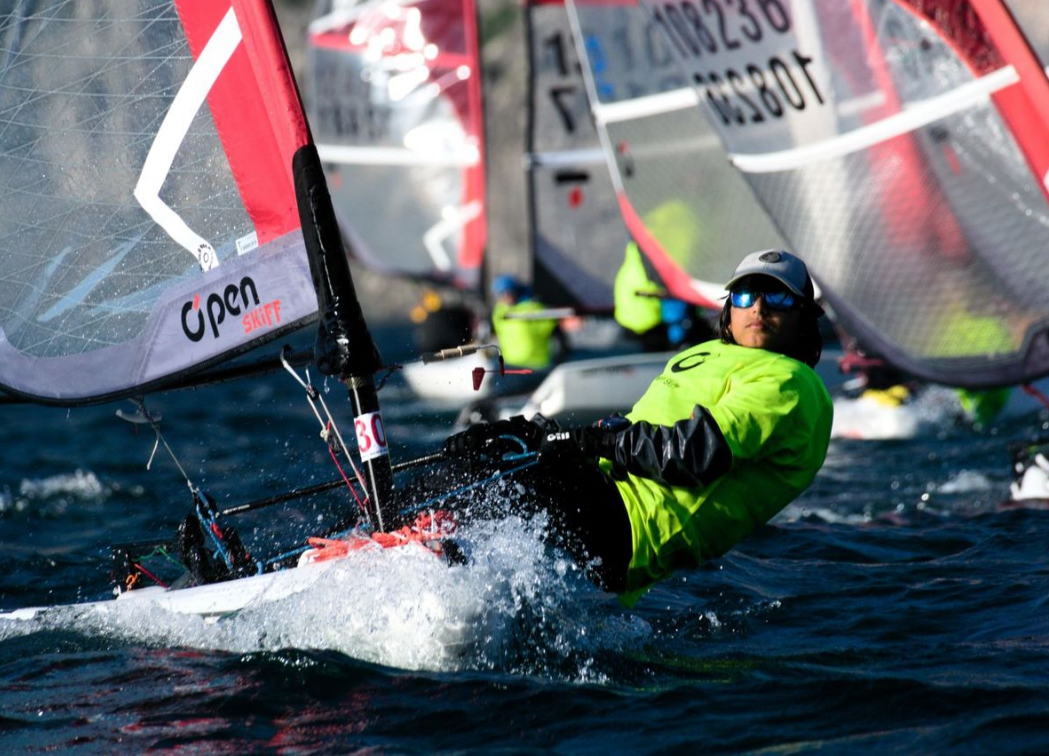 Sailor hiking out hard from a dinghy